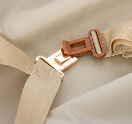 Leather-trimmed buckle on the compression straps inside a Bric's Bellagio suitcase
