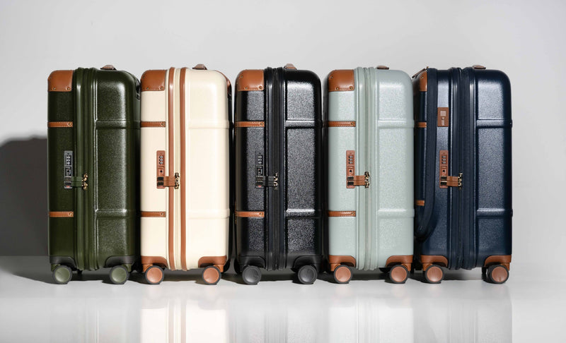 Bric's Bellagio spinners lined up in olive, cream, black, eucalyptus and blue