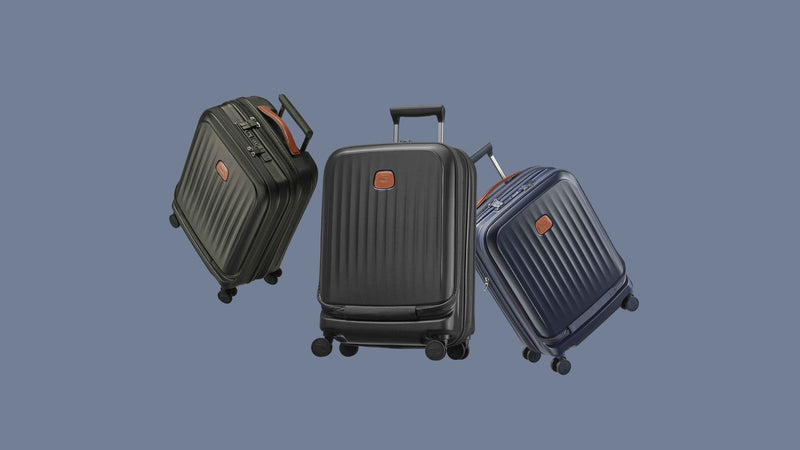 Olive, black and blue Bric's Taormina carry-ons with front laptop compartments, floating on a slate background