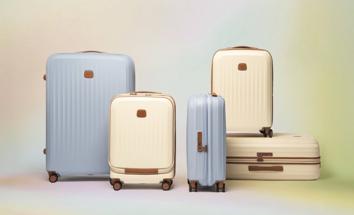 Cream Bric's Taormina carry-on with laptop pocket among Taormina cases in cream and sky blue